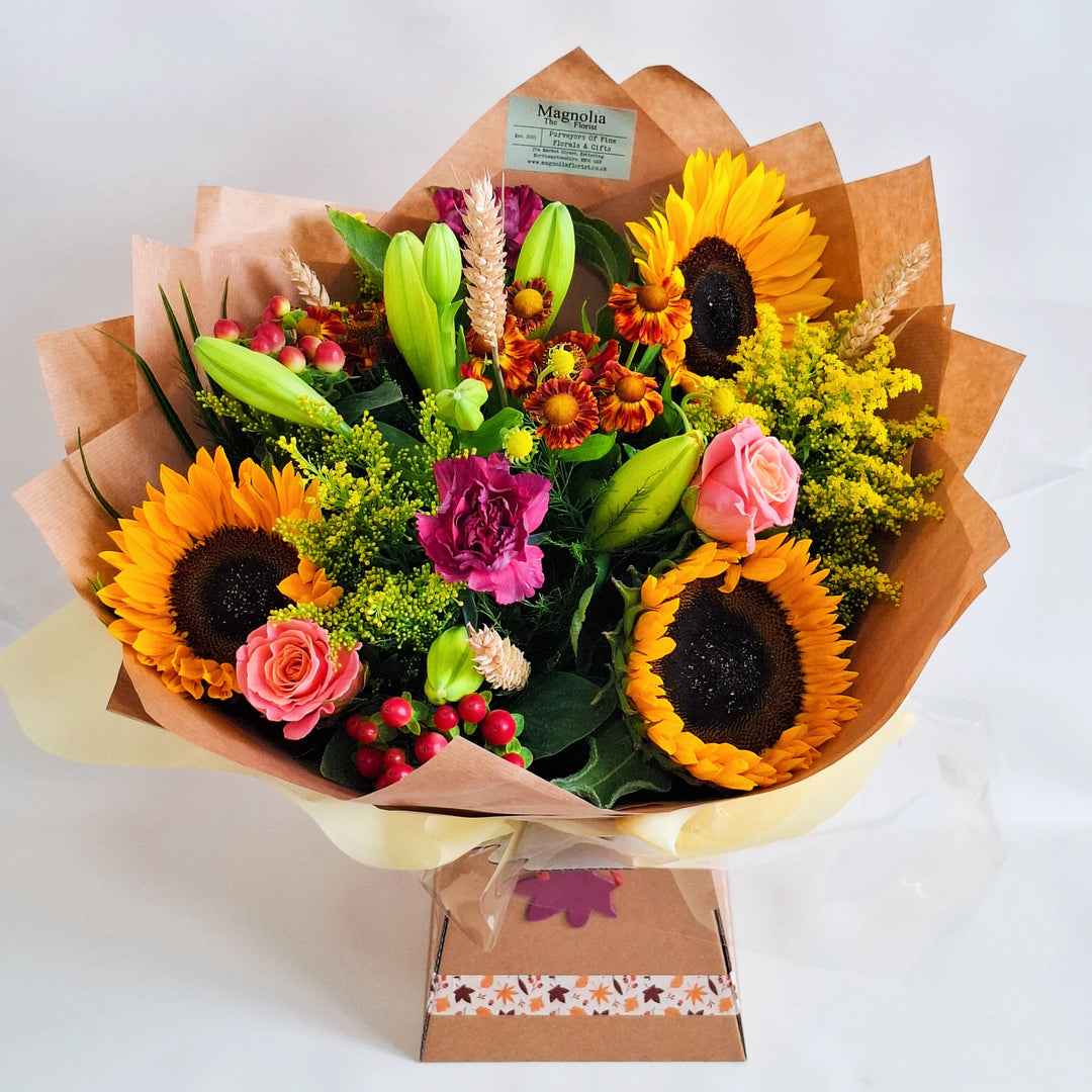 Brampton hand-tied bouquet with autumn flowers in warm red, orange, and yellow tones from Magnolia the Florist UK.