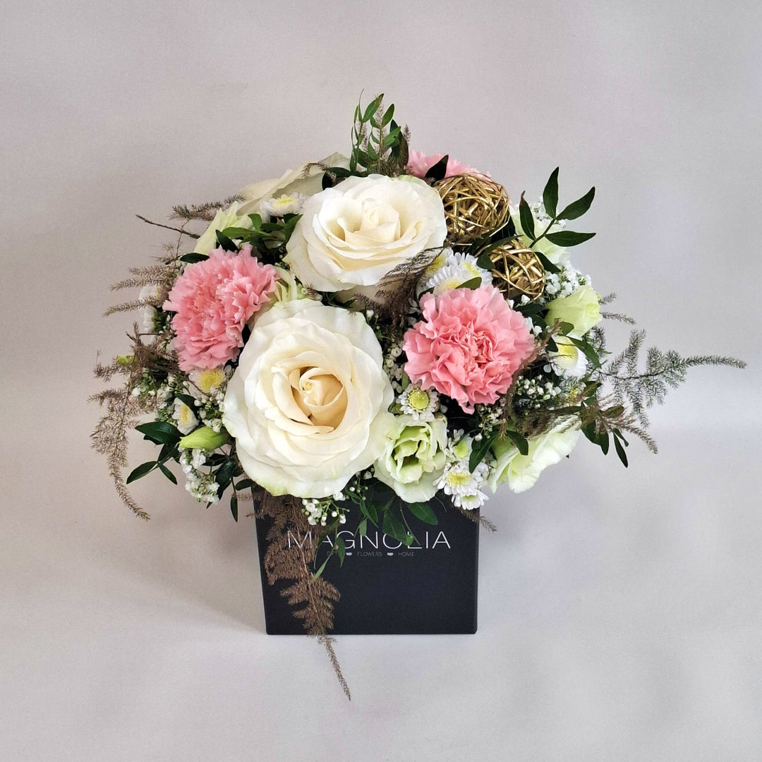Arrangment of pink and white toned flowers in a Magnolia branded box.