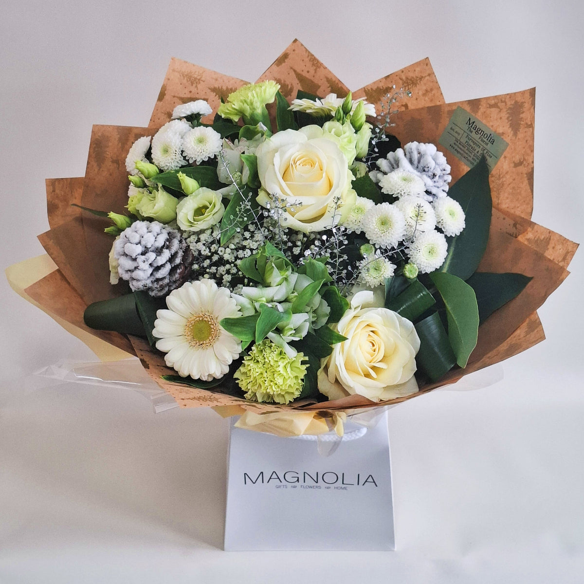 a hand-tied bouuqet of white flowers, with silver and cones. 