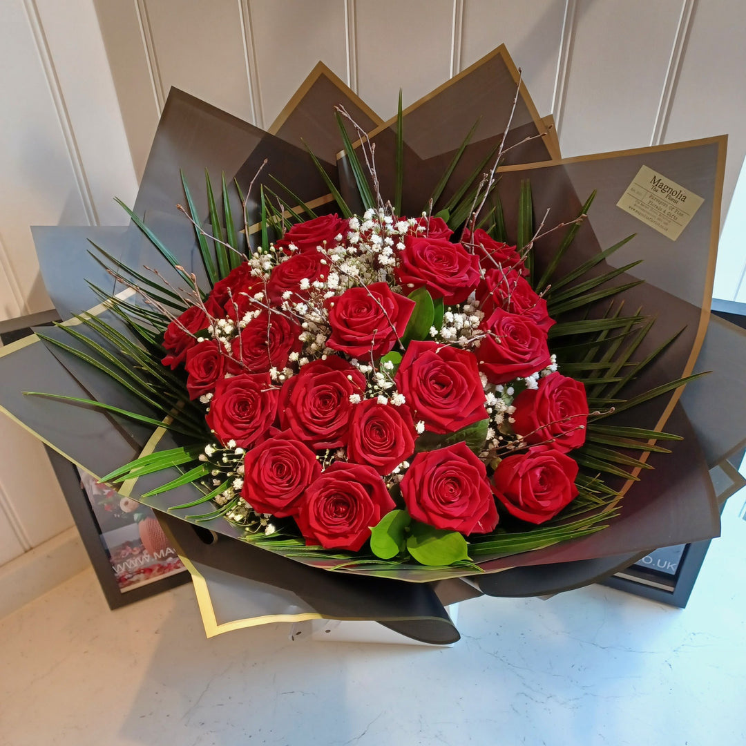 Truly In Love Hand-Tied Bouquet - Magnolia the Florist Indulge in the exquisite beauty of the Truly In Love Hand-Tied Bouquet from Magnolia the Florist. Luxury roses and lush foliage are lovingly arranged by hand, creating a unique masterpiece. Presented in our signature packaging, this bouquet is a luxurious gift that will leave a lasting impression. Please note this item requires 1-day notice to order. For scale purposes, our hand-tied box bags are 18cm (w) by 25cm (h).  1