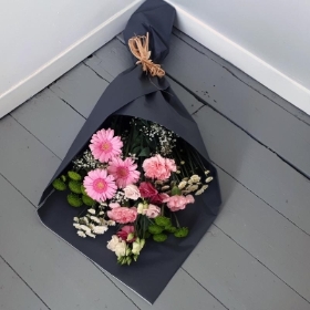 Bouquet of flowers wrapped in eco-friendly paper and tied in natural materials